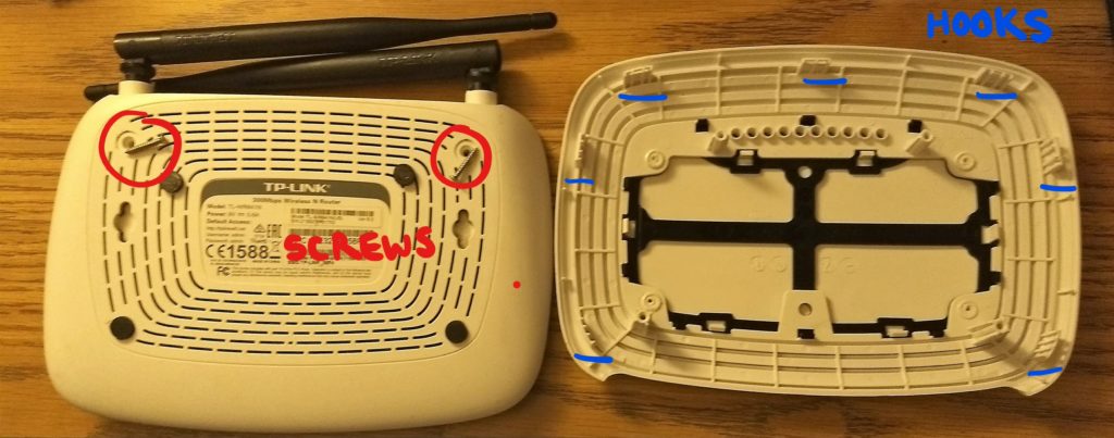 TP-Link router underside showing the screw locations